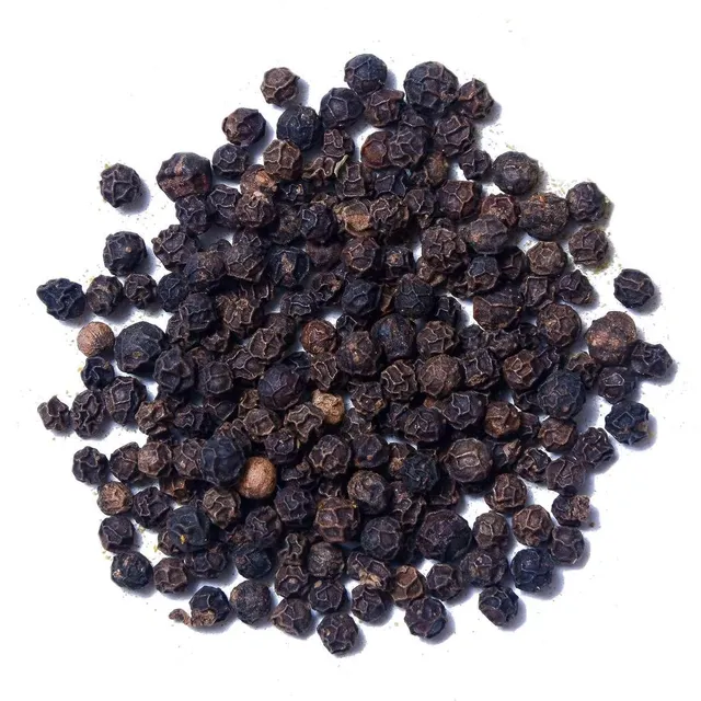Black peppercorns in bowl for seasoning