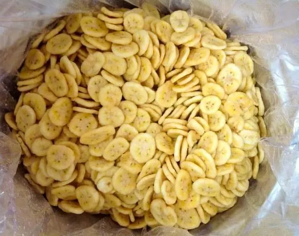 Dried banana slices arranged on wooden dish