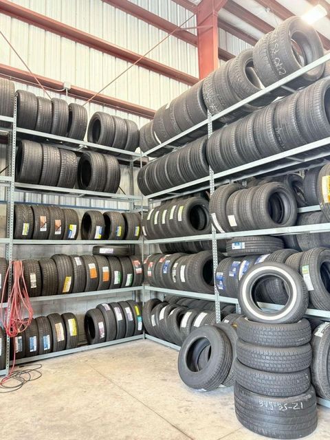 Stacked used auto tires of various sizes