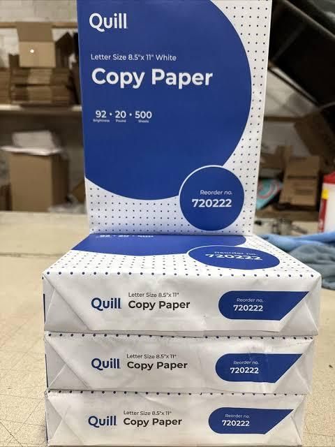 Multiple reams of white A4 copy paper stacked
