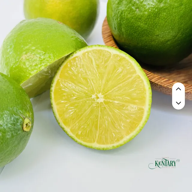 Close-up of premium green lemons with leaves