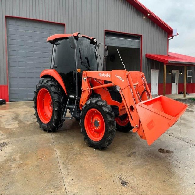 Tractor with grass brush cutter in action