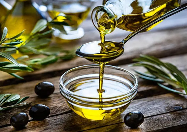 Premium Tunisian Olive Oil pouring over bowl