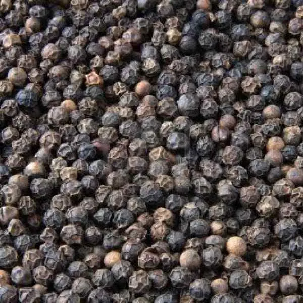 Premium whole black pepper grains close-up