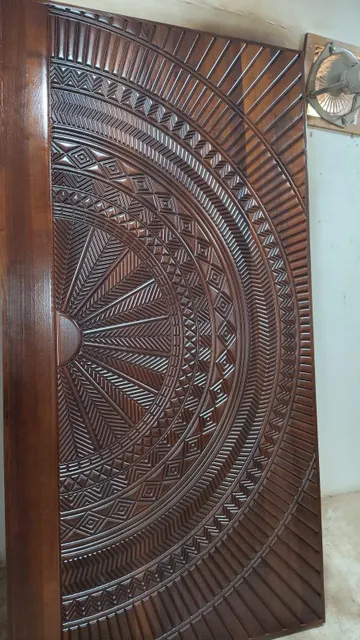 Richly carved teak wood entrance door with ornamental detail