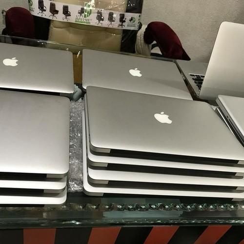 Side view of MacBook laptop showing ports and sleek design