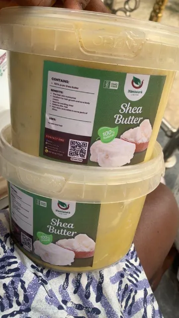Raw Shea Butter in a container with wooden spoon